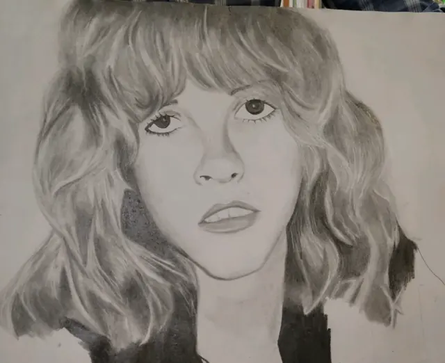Pencil portrait of a woman with wavy, shoulder-length hair and bangs